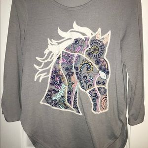 A gray shirt with a horse design.